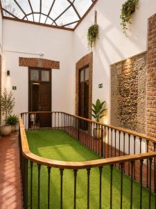 a balcony with green grass in a house at Morada Luna Centro Histórico in Mexico City
