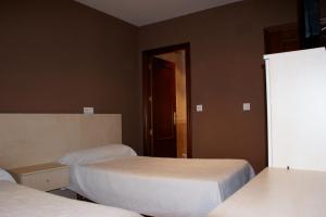 En eller flere senge i et værelse på Hostal Carazo