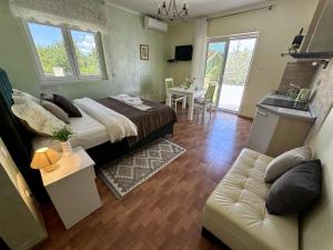 a bedroom with a bed and a couch and a table at Villa Mare Apartments in Tivat +98 photos