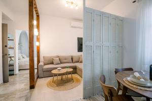 a living room with a couch and a table at Benjamin Luxury Suite by The Eustas in Pylos
