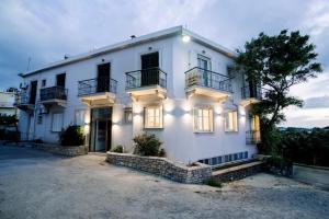 a large white house with its lights on at Benjamin Luxury Suite by The Eustas in Pylos