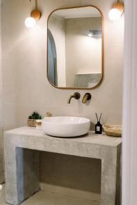 a bathroom with a sink and a mirror at Benjamin Luxury Suite by The Eustas in Pylos +30 photos