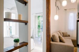 two views of a living room and a room with a couch at Benjamin Luxury Suite by The Eustas in Pylos