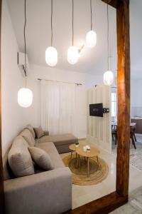a living room with a couch and a table at Benjamin Luxury Suite by The Eustas in Pylos
