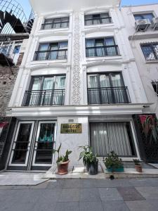 a white building with plants in front of it at The Basilissis Gulhane in Istanbul