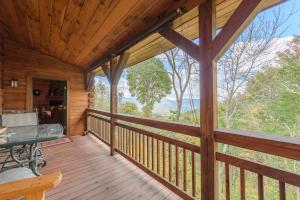 a large porch of a cabin with a table on it at Fox Crossing in Banner Elk +23 photos