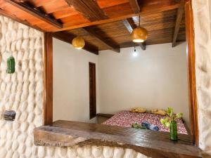 a room with a bed in a room with wooden ceilings at Casa do Parcerito in Cajueiro +15 photos
