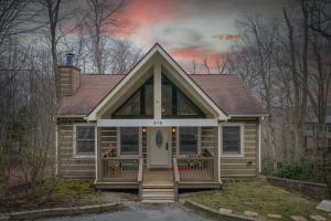 a tiny house with a front porch and a front door at Appalachian Breeze in Blowing Rock