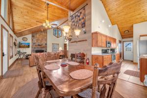 a kitchen and dining room with a wooden table and chairs at Appalachian Breeze in Blowing Rock