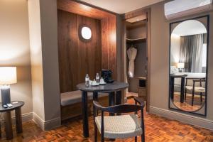 a room with two tables and chairs and a mirror at Maria Condesa Boutique in Mexico City