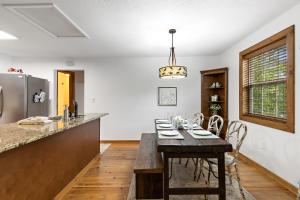 a kitchen with a table with chairs and a counter top at Fehrway to Heaven in Blowing Rock +28 photos
