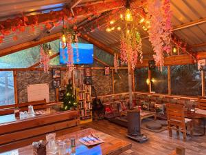 a restaurant with a bar with a christmas tree at Mystic Vibes - Jibhi in Jibhi