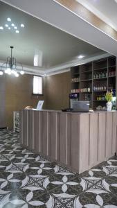 a lobby of a hotel with a reception desk and a counter at Dan plus in Aktobe