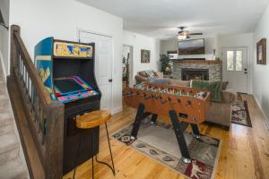 a living room with a foosball table in front of a room at Flat Top Lodge in Blowing Rock