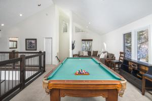 a pool table in the middle of a living room at Flat Top Lodge in Blowing Rock