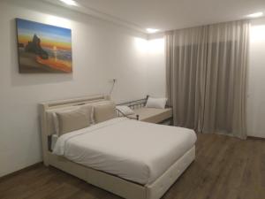 a white bedroom with a bed and a window at Villa Dar Daraa with Pool in Najem +57 photos