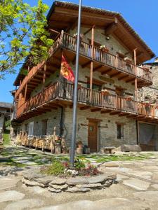 a large wooden building with a balcony on it at Baita Mot in Marmora
