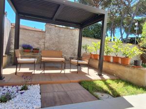 a patio with two chairs and a gazebo at La casa di Aurora in Montopoli in Val dʼArno