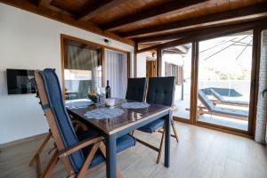 a dining room with a wooden table and chairs at Holiday house "Maria" in Privlaka