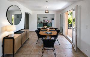 a dining room with a table and a mirror at Villa Bellevue, magnifique vue mer! Piscine chauffée, à10 mns de la plage et du centre! in Cavalaire-sur-Mer