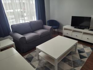 a living room with a couch and a tv at Claymore Inn and Suites in Antigonish