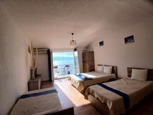 two beds in a room with a view of the ocean at Lake Breeze Aparments - Trpejca in Trpejca