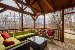 a screened in porch with a couch and two chairs at Appalachian Escape in Blowing Rock