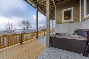 a large deck with a hot tub on a house at Bear The View in Seven Devils