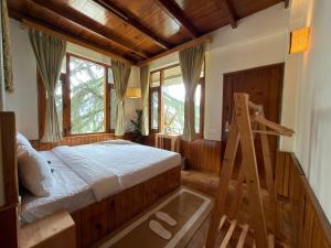 a bedroom with a bed and a ladder in it at Tora House in Nagar