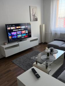 a living room with a large flat screen tv at Home place in Louny