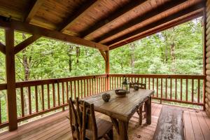 a wooden table on the deck of a cabin at Creek Sound Chalet in Blowing Rock