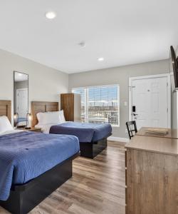 a hotel room with two beds and a large window at The Beach House in Wildwood