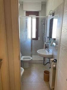 a bathroom with a shower and a toilet and a sink at Guest House 36 private parking in Orbetello +20 photos