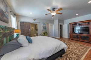 a bedroom with a large bed and a flat screen tv at Red River Retreat in Paso Robles