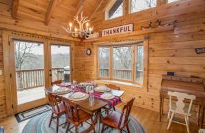 a dining room with a table in a cabin at Sugar Bear in Sugar Mountain