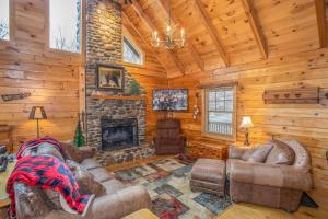 a living room with leather furniture and a fireplace at Sugar Bear in Sugar Mountain +30 photos