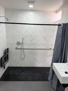 a bathroom with a shower and a sink at Rocky Inn Motel in Lynwood