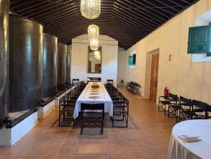 a long dining room with a table and chairs at La Almedina: Palacio de Foronda in Cazorla