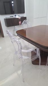 a dining room table with a white chair around it at Erminia Apartaments in Vico Equense