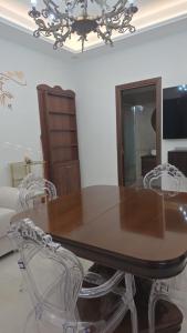 a dining room table with two chairs and a chandelier at Erminia Apartaments in Vico Equense