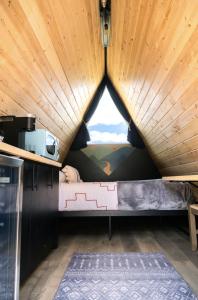a small bedroom in a tiny house with a window at NEW! Unique Modern Glamping Chalet #5 in Orderville +15 photos