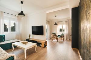 a living room with a couch and a table at Apartments BUBBLES with pool in Gevgelija