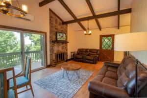 a living room with a couch and a table at Fern Cottage in Beech Mountain