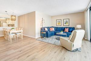 a living room with a blue couch and a table at Sea Colony - 302S Edgewater in Bethany Beach