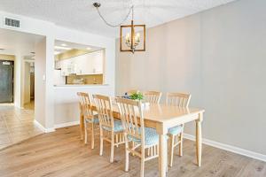 a kitchen and dining room with a wooden table and chairs at Sea Colony - 302S Edgewater in Bethany Beach +33 photos