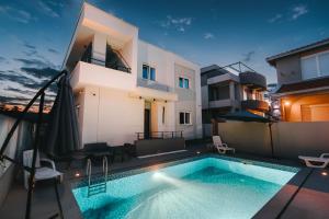 a swimming pool in the backyard of a house at Apartments BUBBLES with pool in Gevgelija