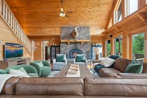 a living room with a couch and a fireplace at Alpine Ridge in Banner Elk