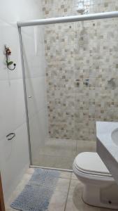 a bathroom with a shower with a toilet and a sink at Pousada dos Cuiabás in Tiradentes