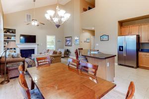 a kitchen and living room with a table and a refrigerator at Bear Trap Dunes - 182 Willow Oak in Ocean View