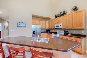 a kitchen with wooden cabinets and a large counter top at Bear Trap Dunes - 182 Willow Oak in Ocean View +46 photos